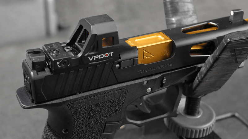 VPDOT D300X red dot sight mounted on carry pistol after training session, on range bag