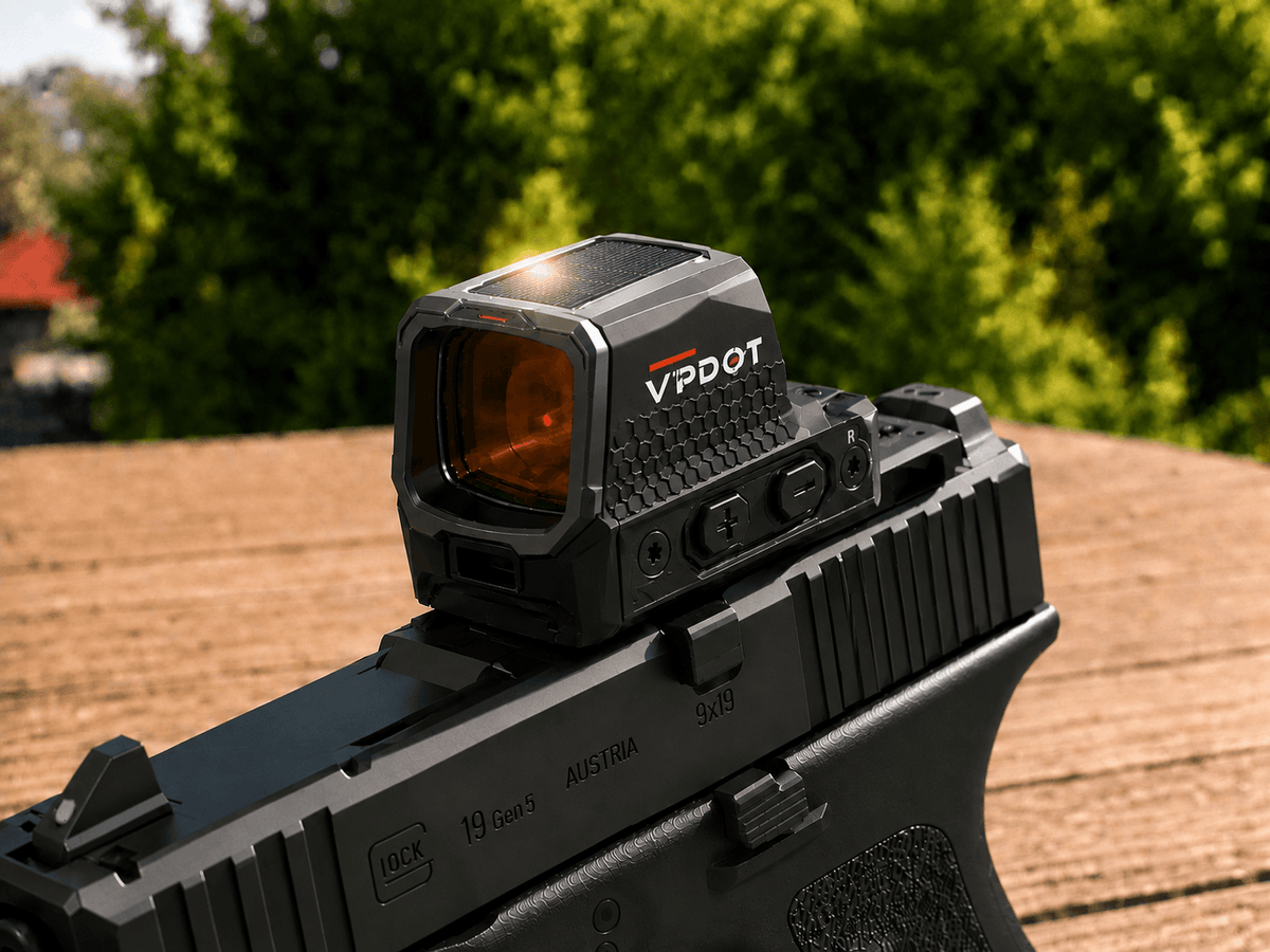 VPDOT solar red dot sight mounted on a black pistol, red dot visible in lens, outdoor background.