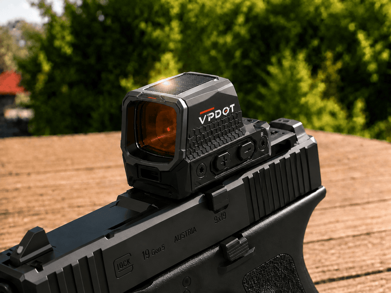 VPDOT solar red dot sight mounted on a black pistol, red dot visible in lens, outdoor background.